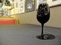Single Black Glass of Wine at The Right Corner with Blur Background Royalty Free Stock Photo