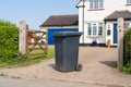 Single Black wheelie bin outside a house. UK