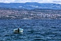 Single blue boat on the sea by the city of Rjeka in background Royalty Free Stock Photo