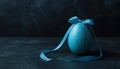 Blue Easter Egg with Ribbon on Dark Background Royalty Free Stock Photo