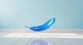 Single blue feather floating in midair against a soft light blue gradient background Royalty Free Stock Photo