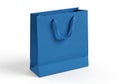A single blue paper gift bag with handles standing upright isolated on white background Royalty Free Stock Photo