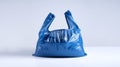 Single blue plastic bag with no contents, placed on a white surface Royalty Free Stock Photo