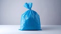 Single blue plastic bag with no contents, placed on a white surface Royalty Free Stock Photo