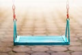 Single blue swing empty people in park and blur background Royalty Free Stock Photo