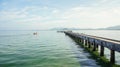 Single boat driving next to a pier Thailand