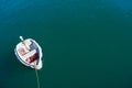 Single boat floating on blue-green sea