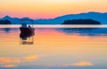 Boat in tinted orange by the sunrise Ionian Sea seascape Lefkada island Greece Royalty Free Stock Photo