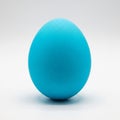 Single Bright Blue Easter Egg on a White Background vibrant Royalty Free Stock Photo