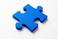A single bright blue jigsaw puzzle piece with distinct interlocking tabs and holes isolated on white background Royalty Free Stock Photo