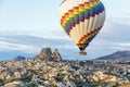 Beautiful bright hot air balloon floats above town in Cappadoccia, Turkey