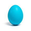 Single bright turquoise blue egg casting a subtle shadow on a white background vibrant Royalty Free Stock Photo