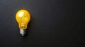 Bright Yellow Light Bulb on Black Background Innovation Idea Concept AI generated. Royalty Free Stock Photo