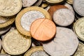 A Single British Penny on Top of a Pile of Coins