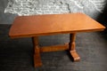 Single brown table with empty surface and carved legs in the loft interior