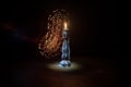 Single burning candle. Light of flame and flowing candle wax, dark background