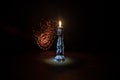 Single burning candle. Light of flame and flowing candle wax, dark background Royalty Free Stock Photo