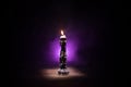 Single burning candle. Light of flame and flowing candle wax, dark background Royalty Free Stock Photo