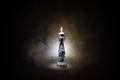 Single burning candle. Light of flame and flowing candle wax, dark background Royalty Free Stock Photo