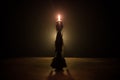 Single burning candle. Light of flame and flowing candle wax, dark background Royalty Free Stock Photo