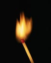 Single burning match on black background Royalty Free Stock Photo