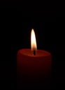 Single burning red candle Royalty Free Stock Photo