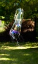 Single bursting soap bubble outside, high shutter speed. Bubble bursts outside in mid air, frozen motion. Failure concept Royalty Free Stock Photo