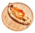 Single calzone italian pizza on wooden plate isolated over white background Royalty Free Stock Photo