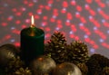 Christmas arrangement with a candle and pine cones on greenery Royalty Free Stock Photo