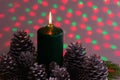 Christmas arrangement with a candle and pine cones on greenery Royalty Free Stock Photo