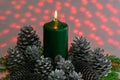 Christmas arrangement with a candle and pine cones on greenery Royalty Free Stock Photo