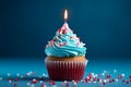 Single candle atop a blue cupcake with vibrant red sprinkles Royalty Free Stock Photo