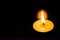 A single candle with bright flames in a dark background Royalty Free Stock Photo