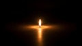 Single candle flame glowing in darkness providing light source view Royalty Free Stock Photo