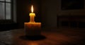 A single candle, a warm glow in the quiet room
