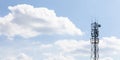 Single cell tower, cellular base station, antenna, transmitter on cloudy blue sky wide background, copy space Telecommunication Royalty Free Stock Photo