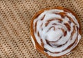 Single Chelsea bun on rustic table Royalty Free Stock Photo