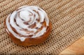 Single Chelsea bun on rustic table Royalty Free Stock Photo