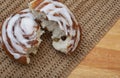 Single Chelsea bun on rustic table Royalty Free Stock Photo