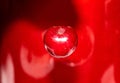 Single cherry on the glossy red background, abstract food photography Royalty Free Stock Photo