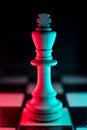 Single chess king. Good or bad side. Red and blue light Royalty Free Stock Photo