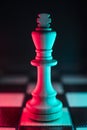 Single chess king. Good or bad side. Red and blue light Royalty Free Stock Photo