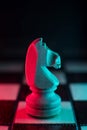 Single chess knight. Good or bad side. Red and blue light Royalty Free Stock Photo