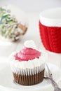 Single Christmas homemade chocolate cupcake with frosting white pink buttercream. Royalty Free Stock Photo