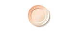 A single, clean, light peach colored plate casting a soft shadow on a pure white background Royalty Free Stock Photo