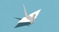 Minimalist white origami crane casting a shadow on a blue background Royalty Free Stock Photo