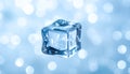 Single Ice Cube Floating with Blue and White Bokeh Lights Background frozen water Royalty Free Stock Photo