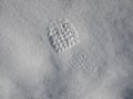 Single clearly defined footprint of a shoe or boot in snow with copy space alongside Royalty Free Stock Photo