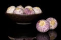Single clove garlic isolated on black glass Royalty Free Stock Photo