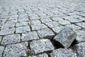 Single cobble out of the structure on a cobblestone street in an old medieval city. Gray paved boulevard made of stones. Urban